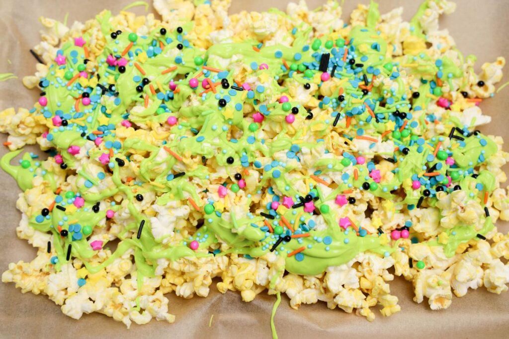 Summerween Horror Popcorn with green drizzled neon candy melts.